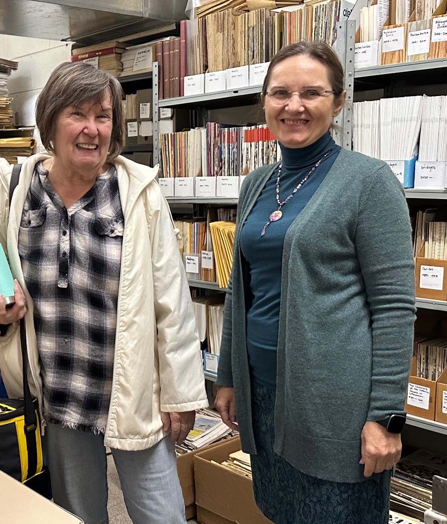 Periodical Library volunteer, Aušra Zarins, and Karilė Vaitkutė, Museum Genealogist, pose in the museum Periodicals Library.